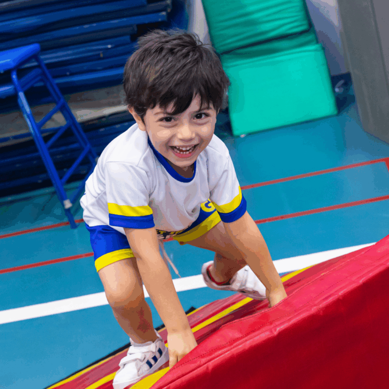 Toddler Movement Classes in Dubai - boy climbing and smiling